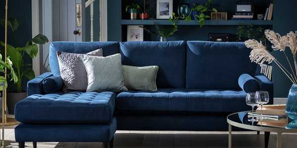 The blue Habitat Hudson reversible corner velvet sofa in a glam lounge setting.